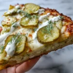 Pickle Pizza and Other Wild Street Food Combos Worth Trying 5 Perfectly baked pickle pizza slice held up close showing toppings and crust